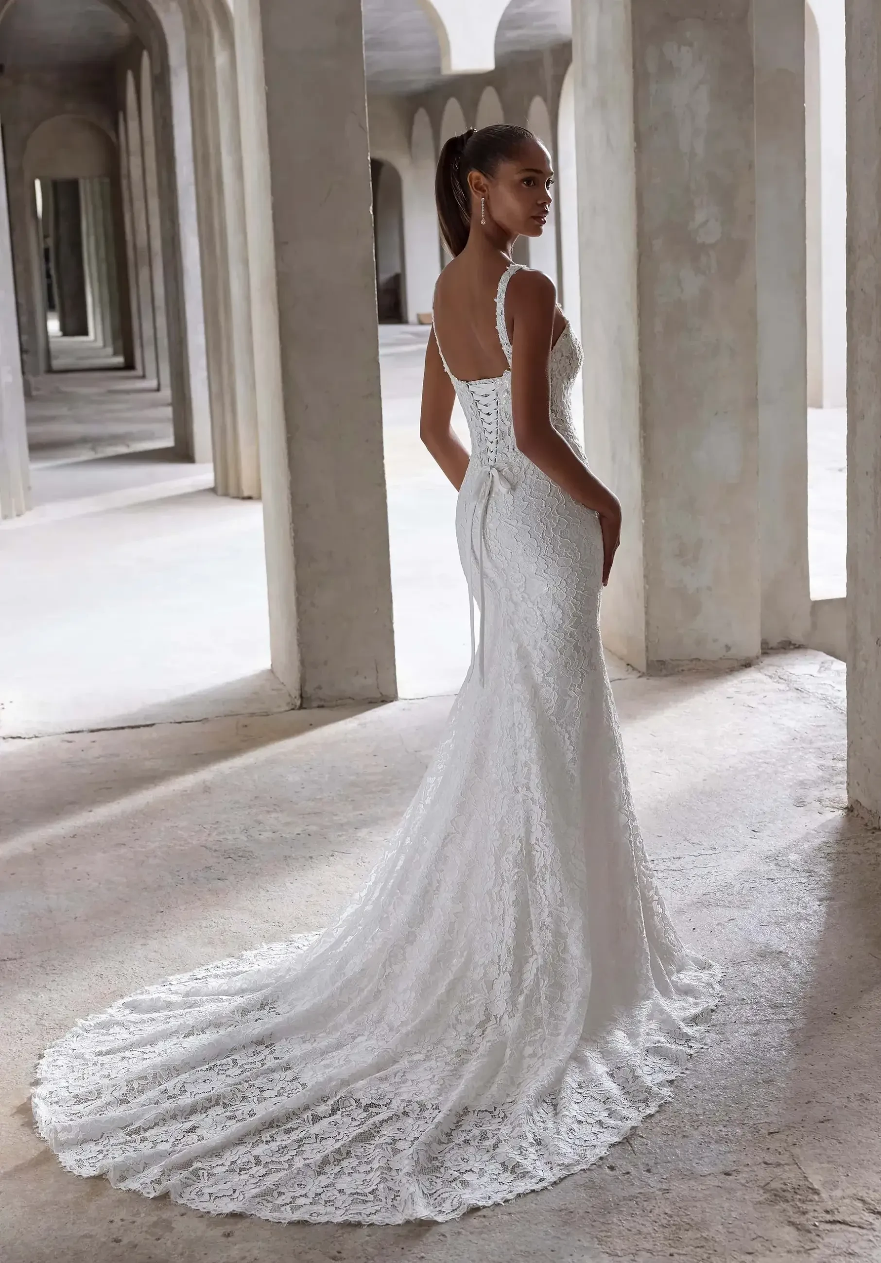 model is wearing a sleeveless fit and flare bridal gown
