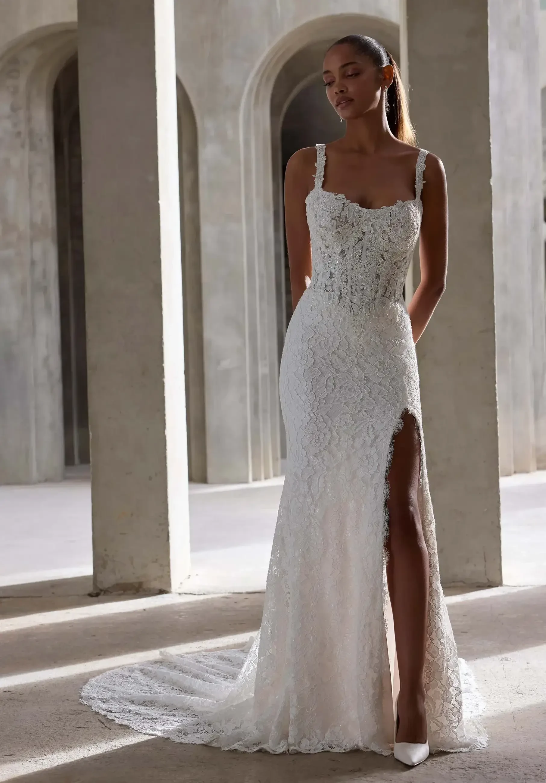 model is wearing a sleeveless fit and flare bridal gown
