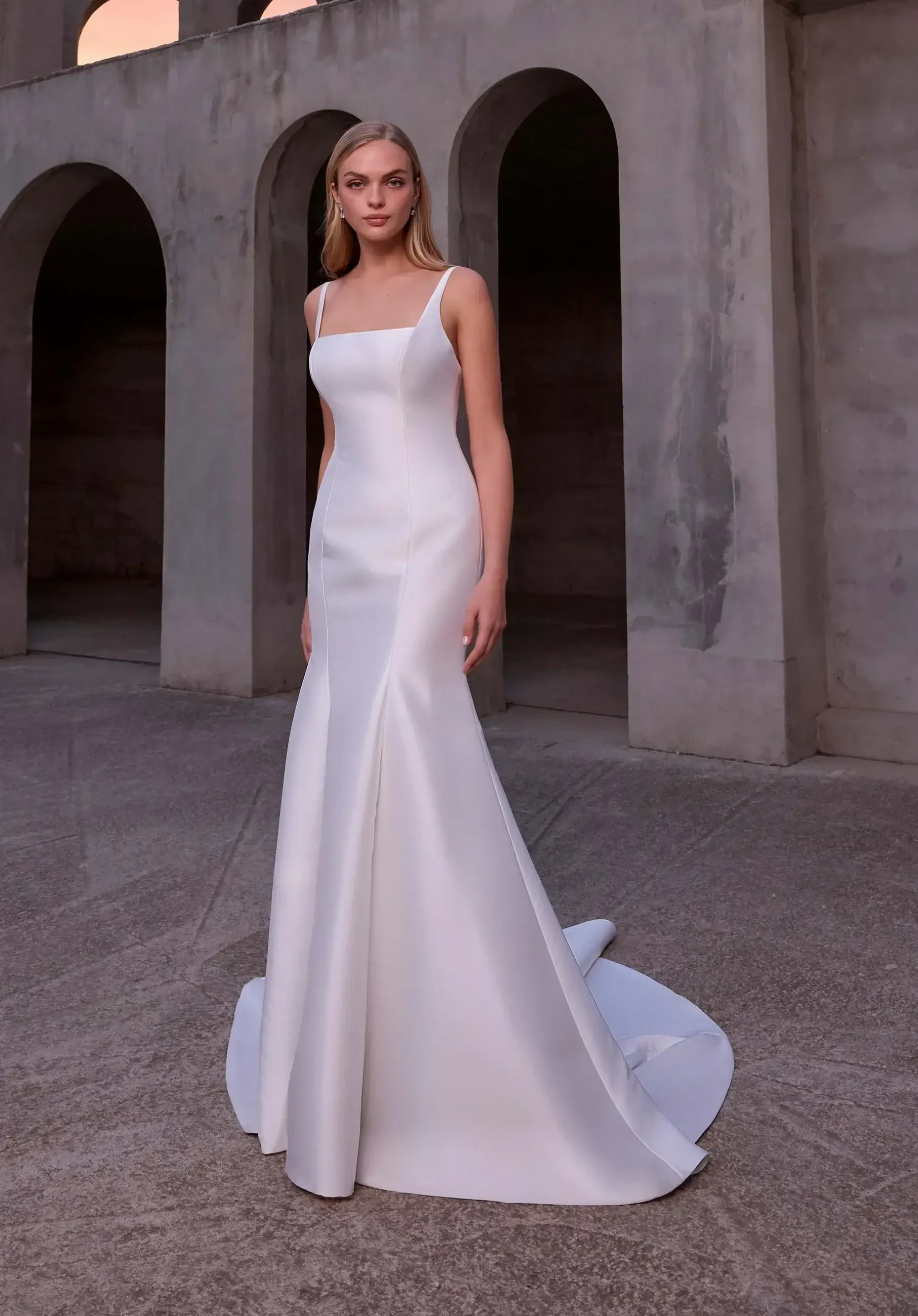 model is wearing s fit and flare wedding dress with a detachable overskirt