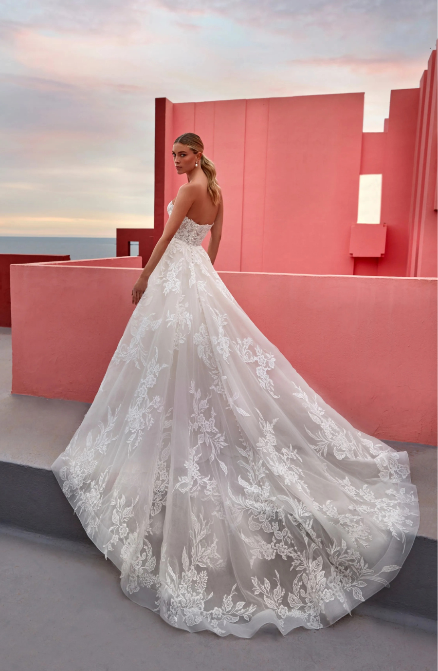 model is wearing a strapless ball gown wedding dress