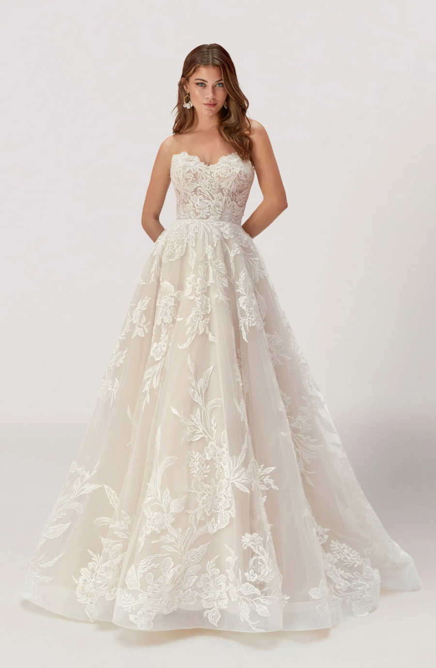 model is wearing a strapless ball gown wedding dress