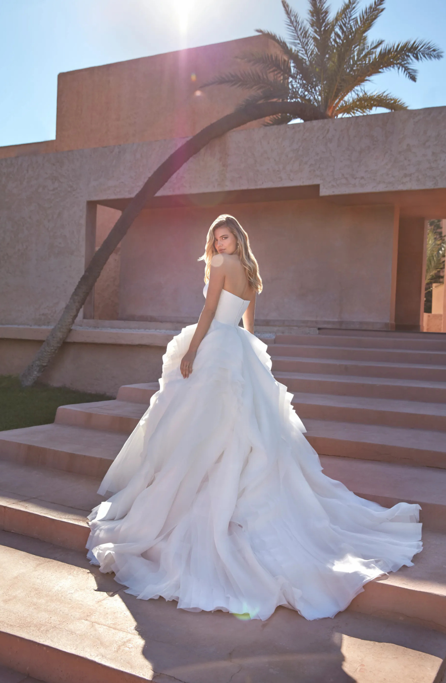 model is wearing a strapless ball gown 