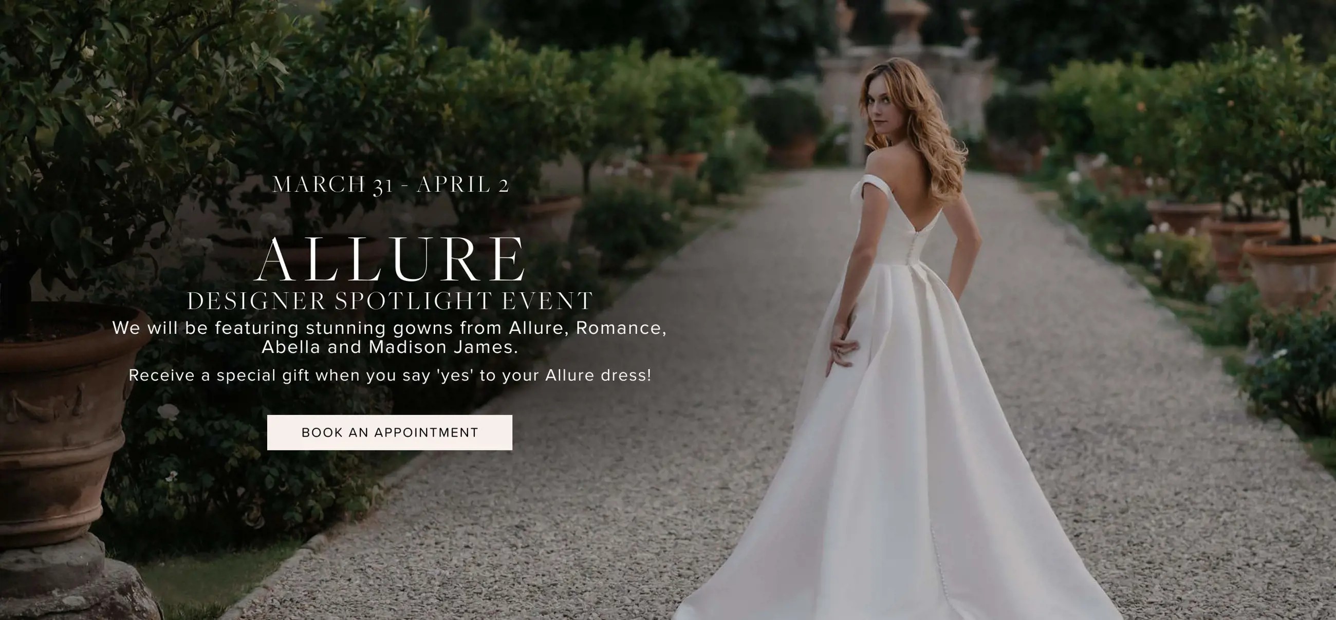 Allure trunk show at Bliss Bridal. Model wearing bridal dress facing back.